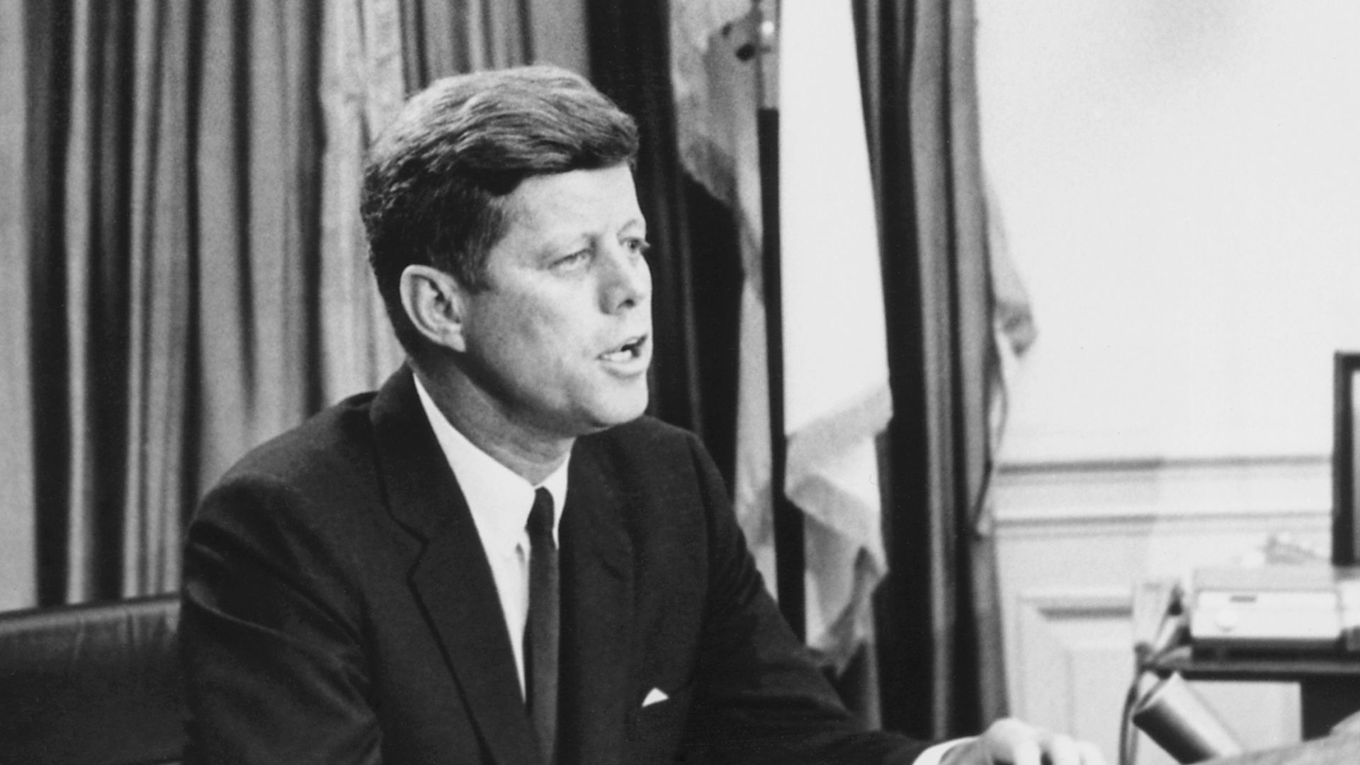 United States President John F. Kennedy addresses the nation on civil rights via television, speaking from the Resolute desk in the Oval Office of the White House.