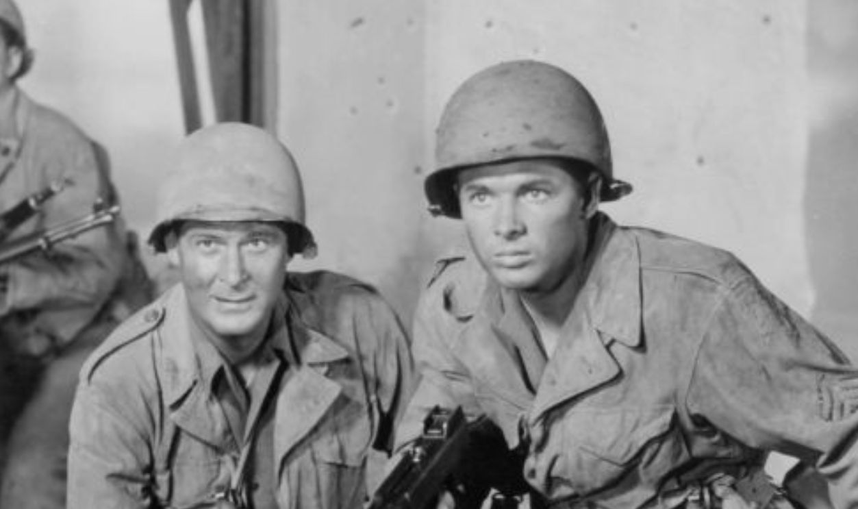 Audie Murphy with group of other soldiers in a scene from the film 'To Hell And Back', 1955.