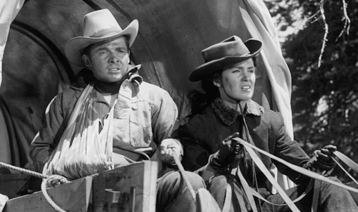Audie Murphy and Gail Storm riding in a stage coach in a scene from the film 'The Kid From Texas', 1950.