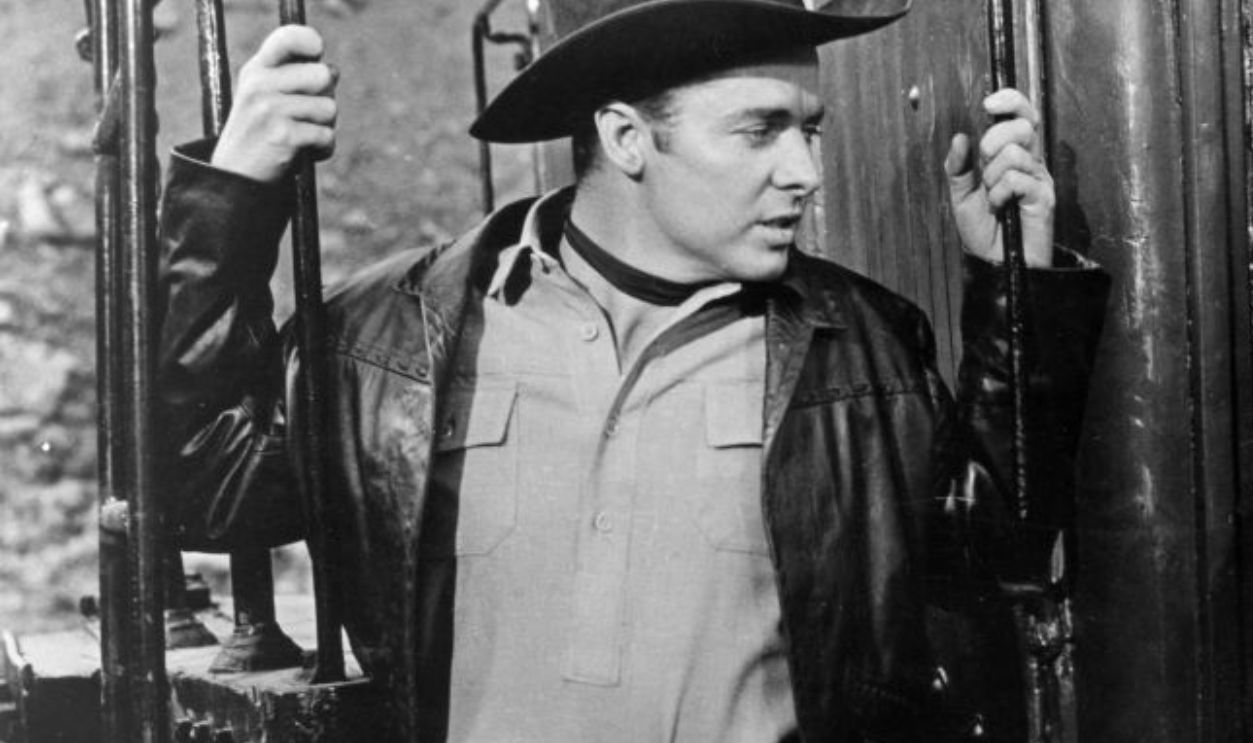 1957: Actress Elaine Stewart teases Audie Murphy (1924-1971) in a scene from the Universal-International Technirama action thriller 'Night Passage'. 