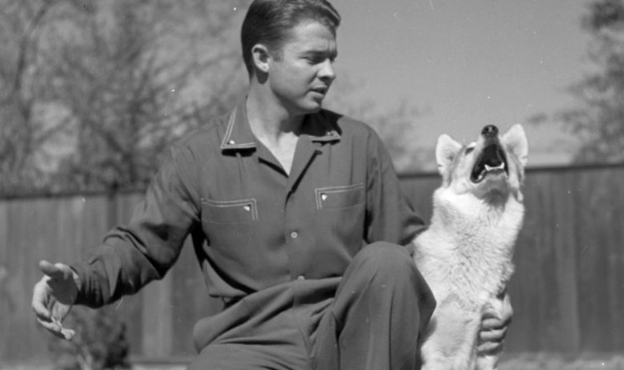 PERRIS,CALIFORNIA - CIRCA 1954: Audie Murphy poses with his dog in Perri,CA.