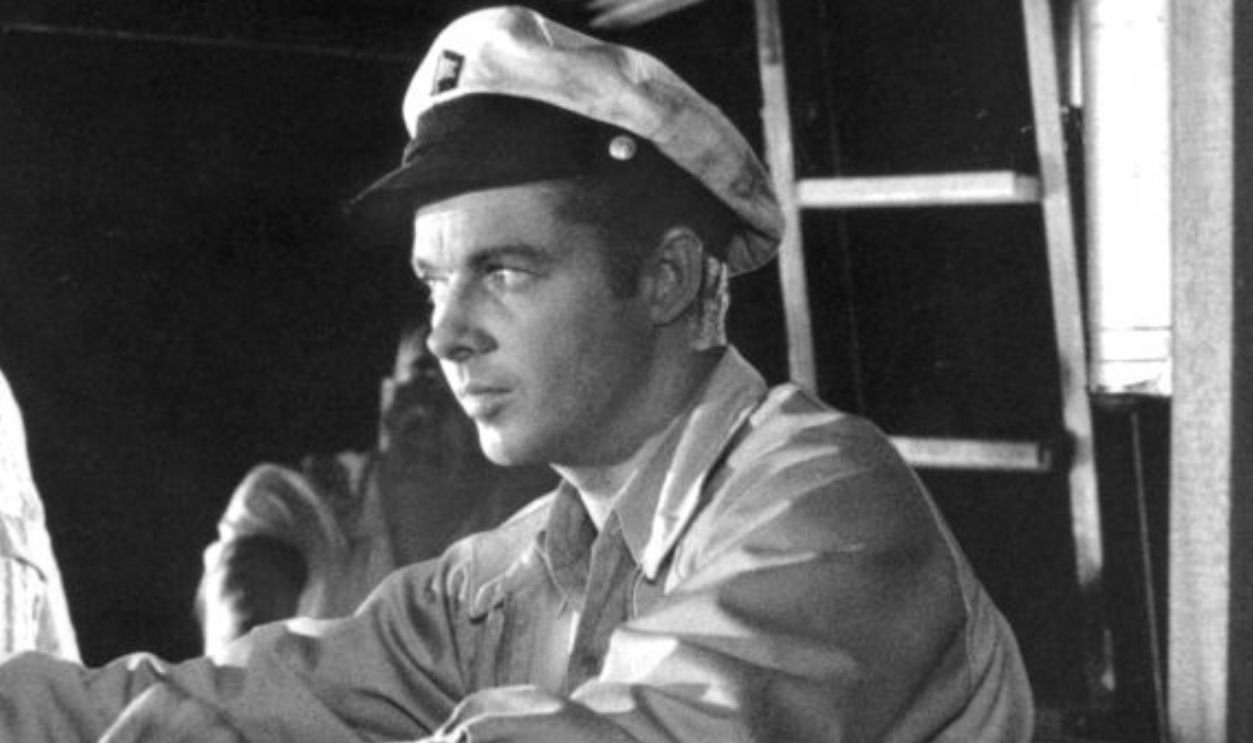 Eddie Albert pointing gun at Audie Murphy in a scene from the film 'The Gun Runners', 1958. 