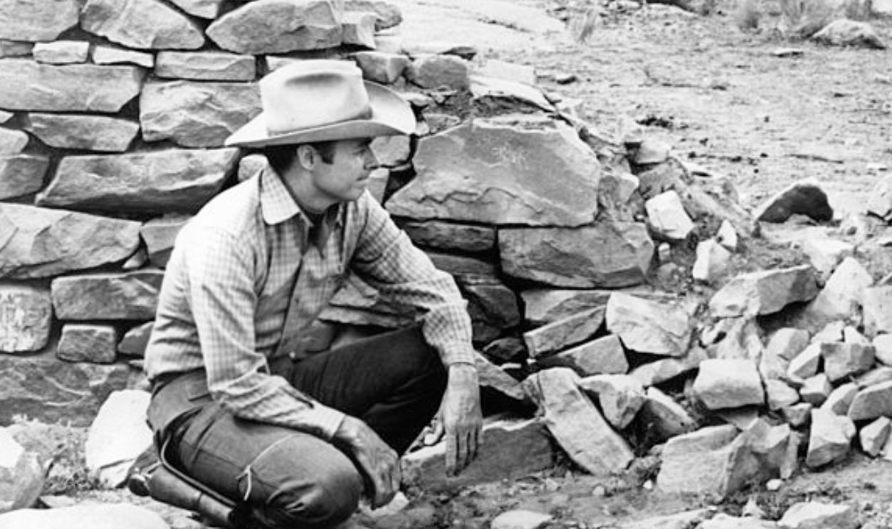 Audie Murphy and director Earl Bellamy contemplate how to approach the next sequence in a scene from the film 'Gunpoint', 1966.