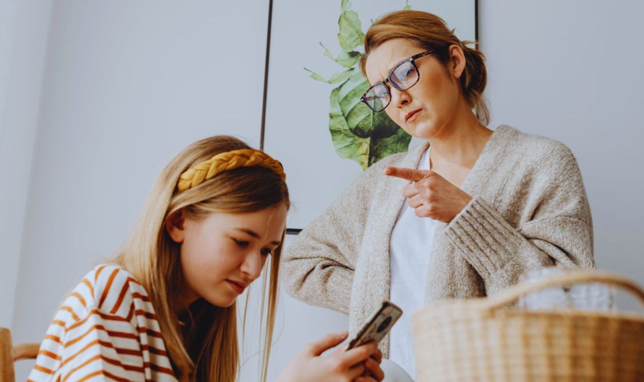 Mother Scolding Teenage Daughter Using Phone