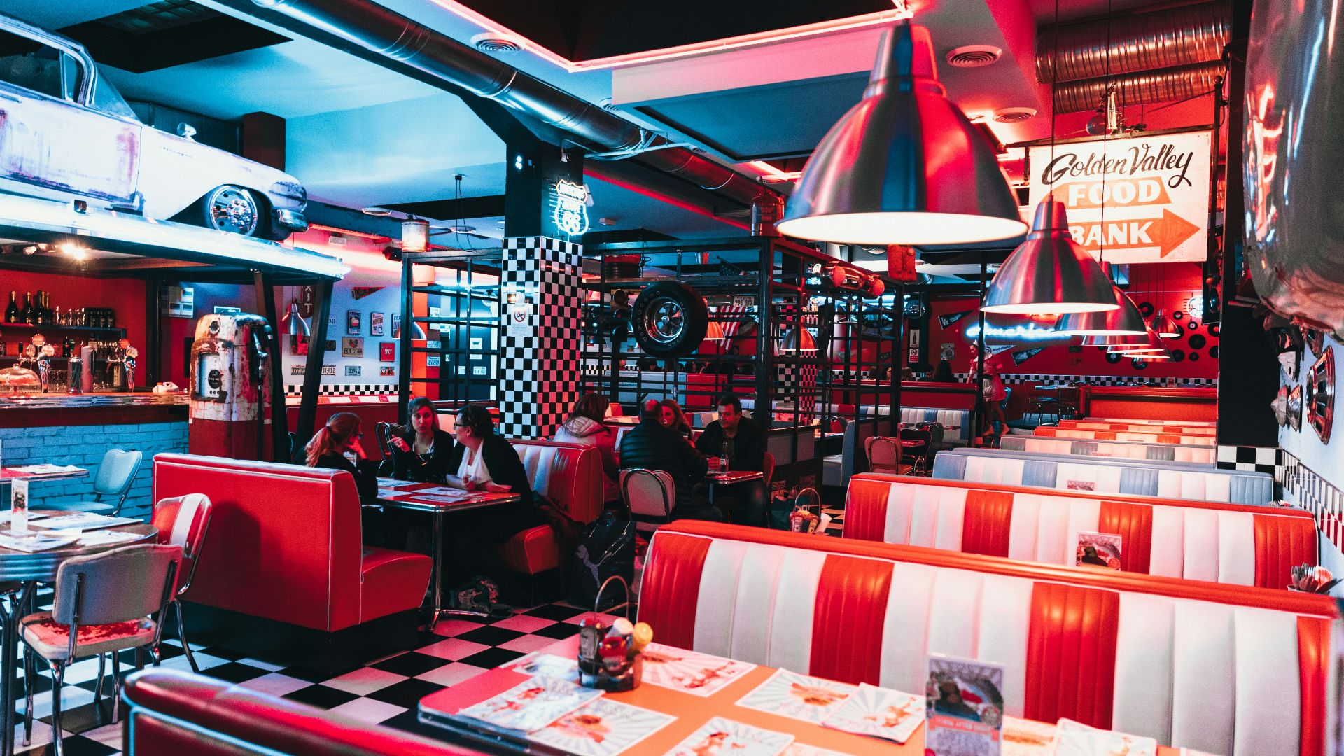 a restaurant with red and white checkered tables and booths
