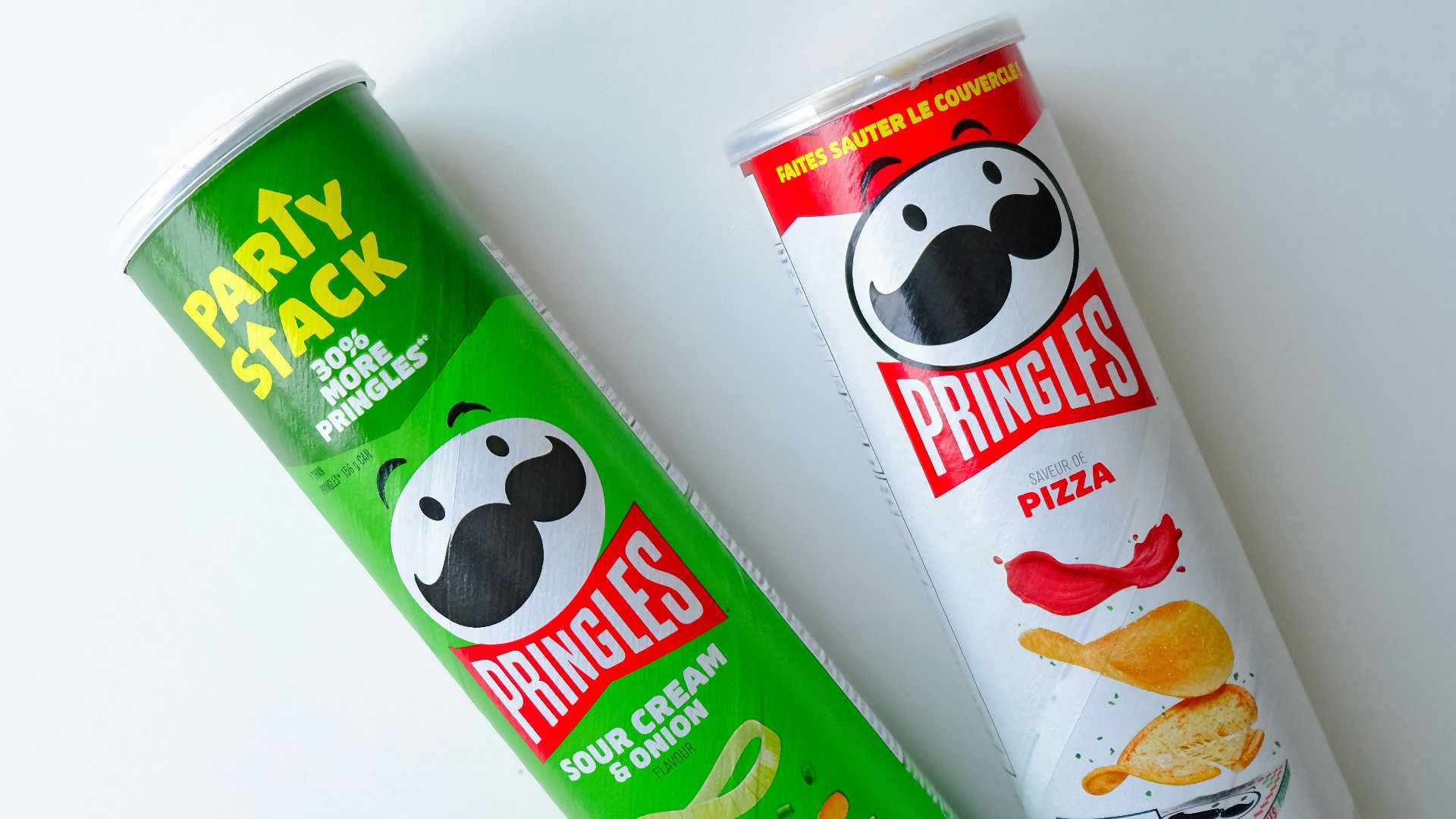 a tube of pringles next to a tube of chips