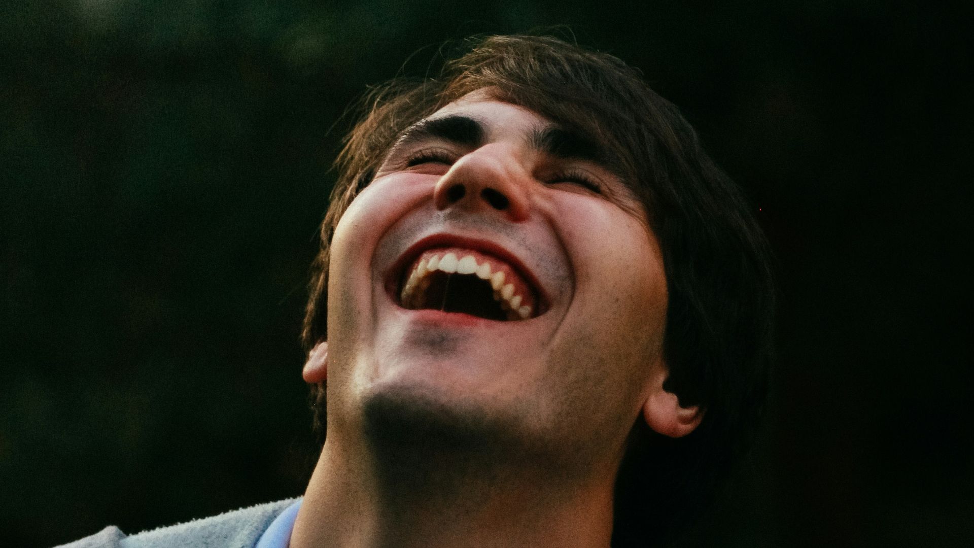 man in gray sweater smiling