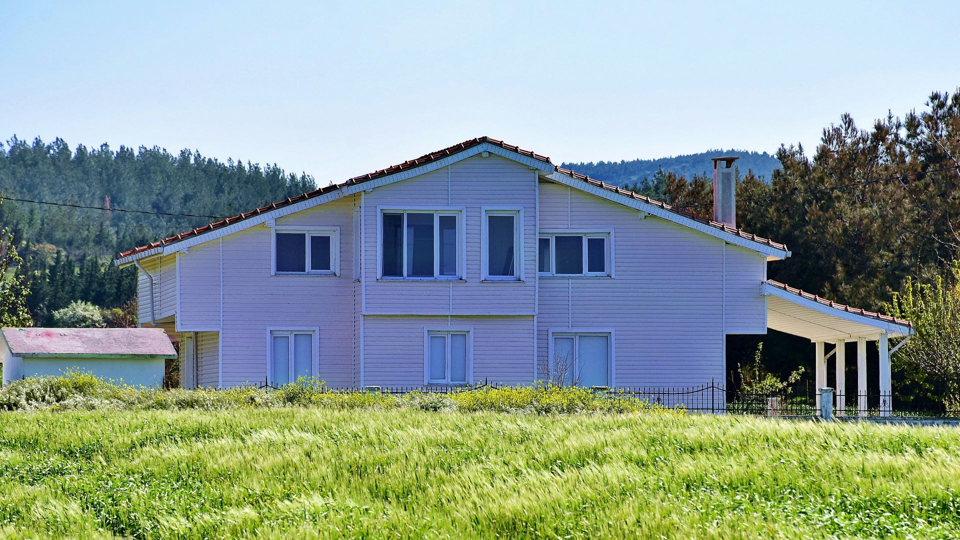 white and brown wooden house on green grass field during daytime
