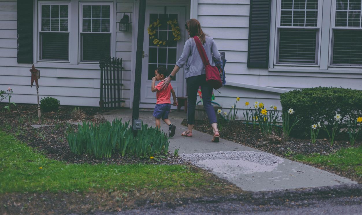 Woman and Boy in Front of House