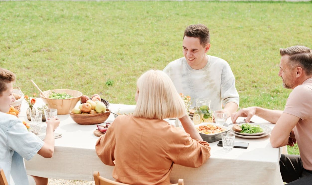 A Family Eating Outdoors Together