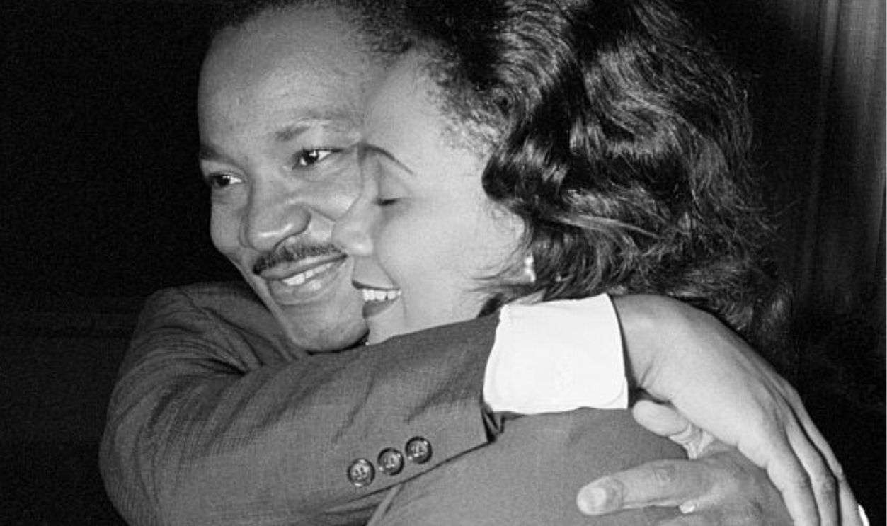 Dr. Martin Luther King, Jr. hugs his wife Coretta during a news conference following the announcement that he had been awarded the Nobel Peace Prize.