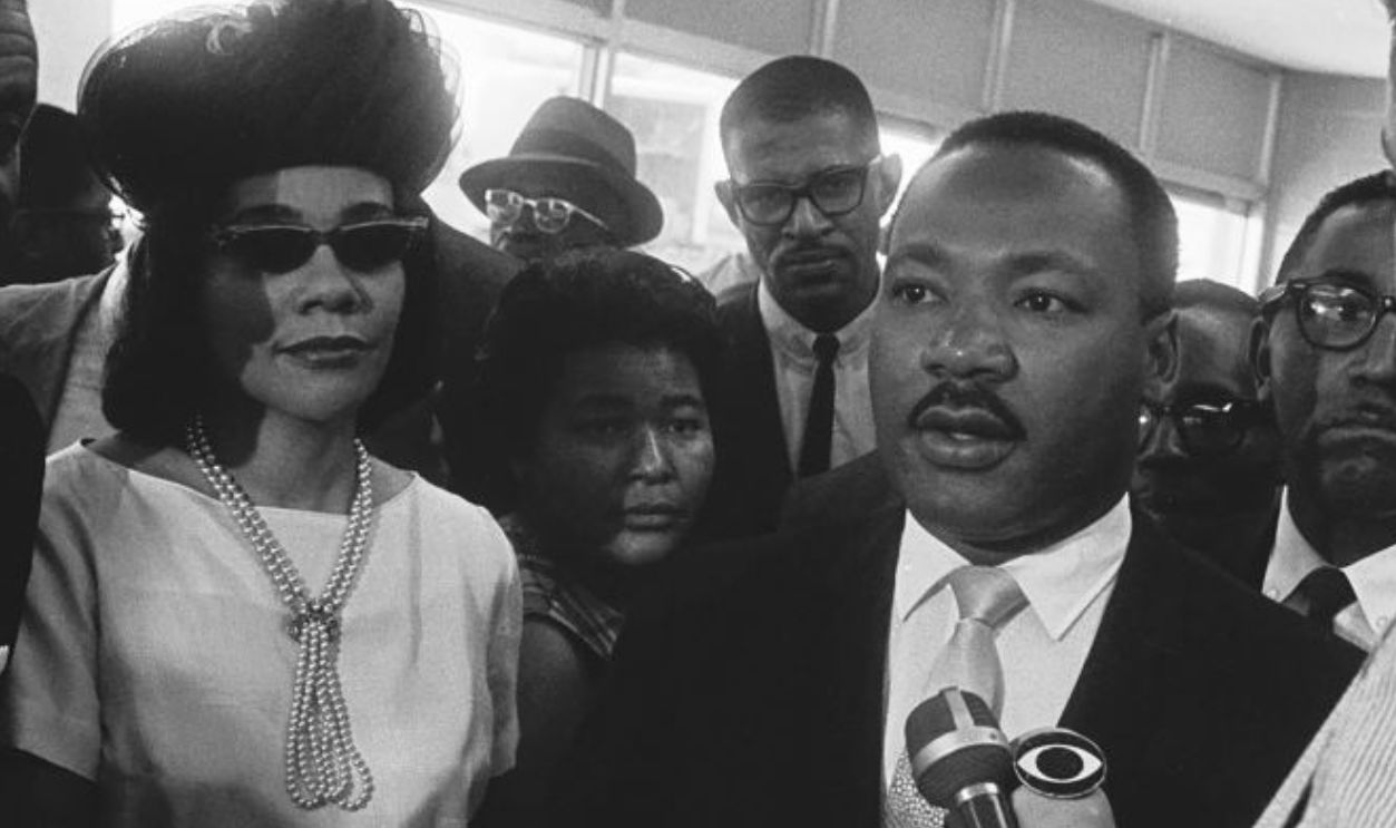 A CBS News reporter interviews Dr Martin Luther King as Reverend Fred Shuttlesworth and Coretta Scott King look on during the SCLC Conference on August 12, 1965 in Birmingham, Alabama. 