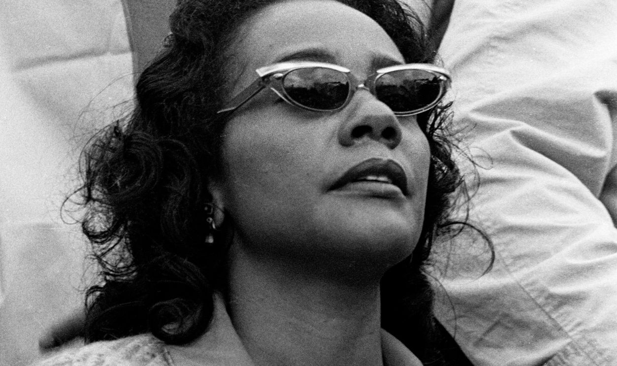 John Lewis and Coretta Scott King listen to Dr. King deliver his How Long, Not Long Speech on the steps of the Alabama State Capitol in Montgomery. Selma to Montgomery March. March 25, 1965. 