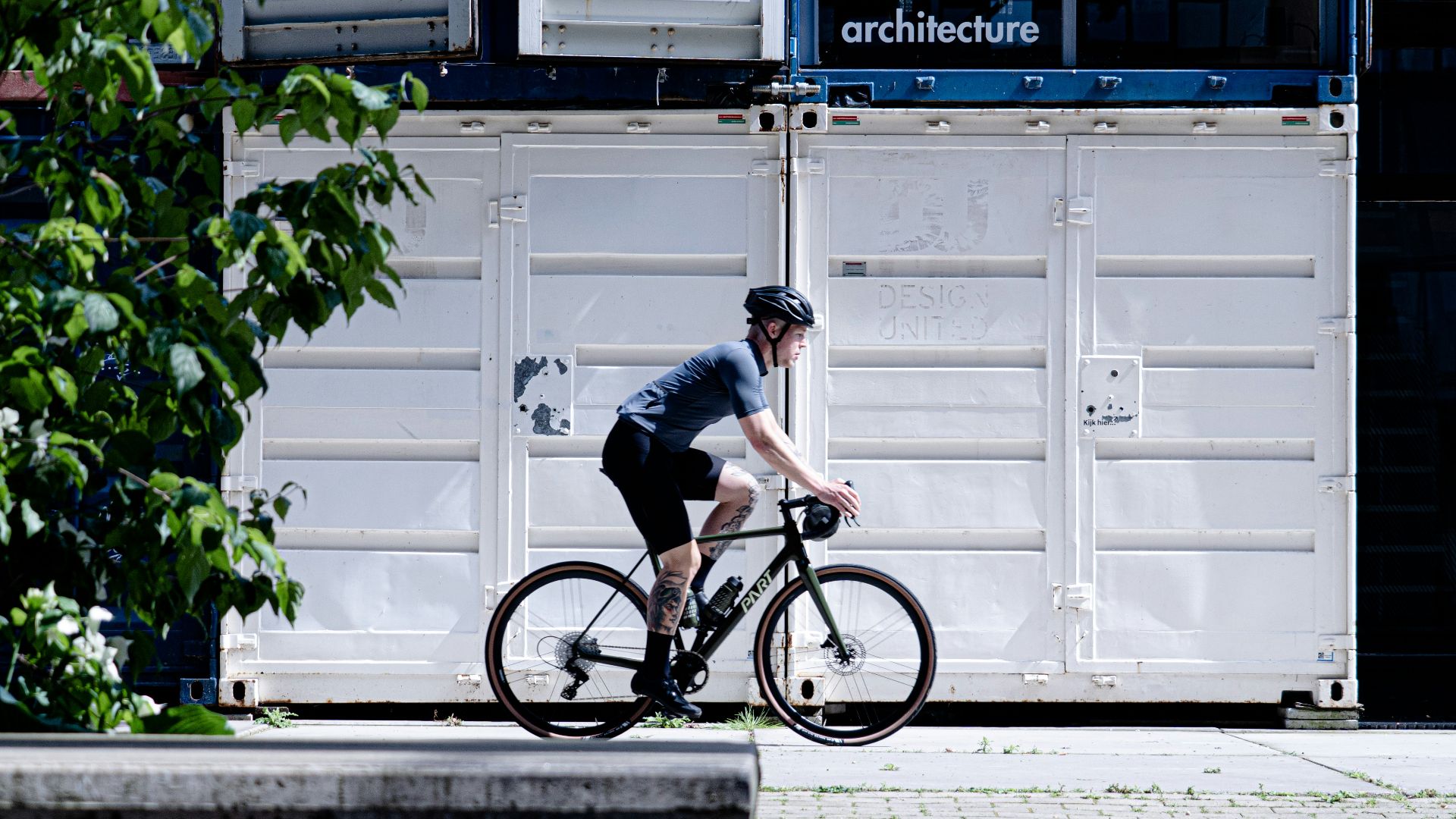 man in black t-shirt riding bicycle during daytime