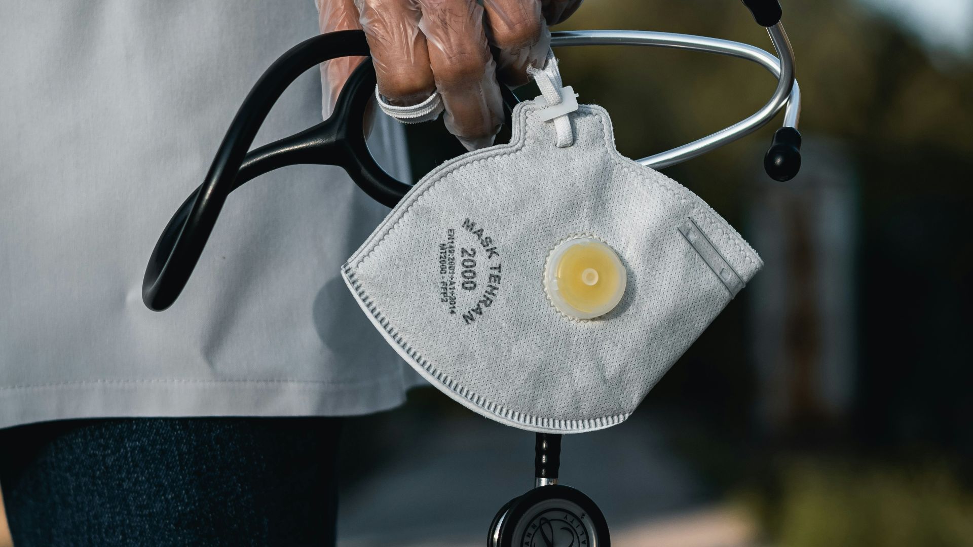 person in blue denim jeans with gray and black metal padlock