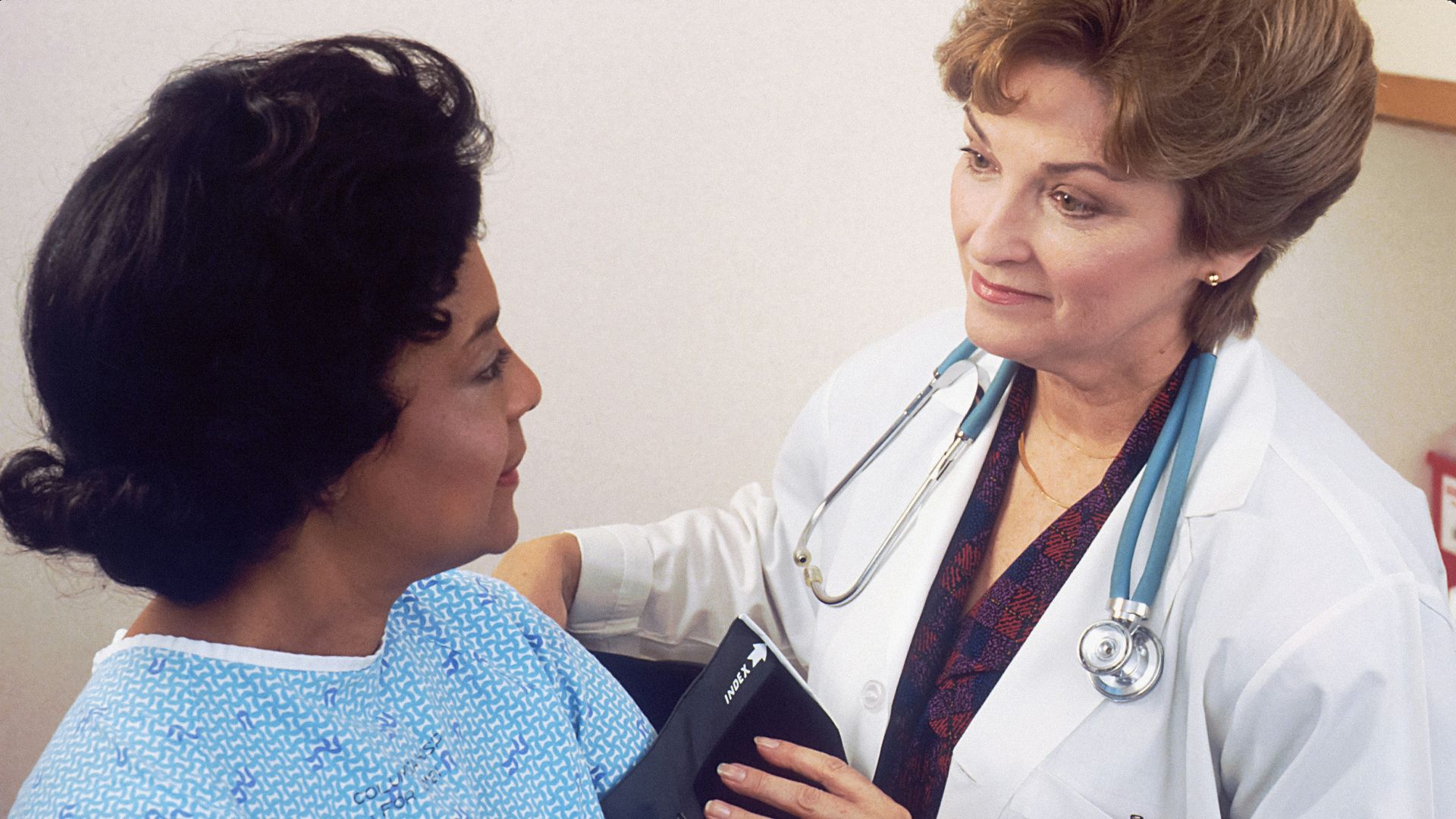 a woman with a stethoscope talking to another woman