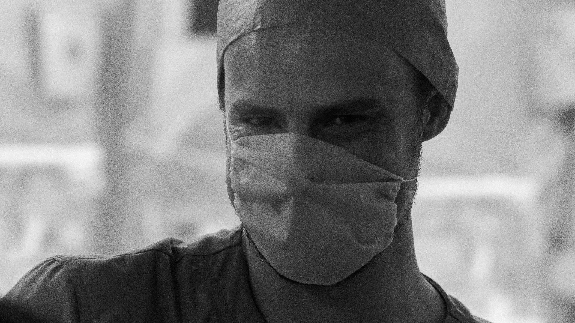 man in black crew neck shirt wearing white bandana