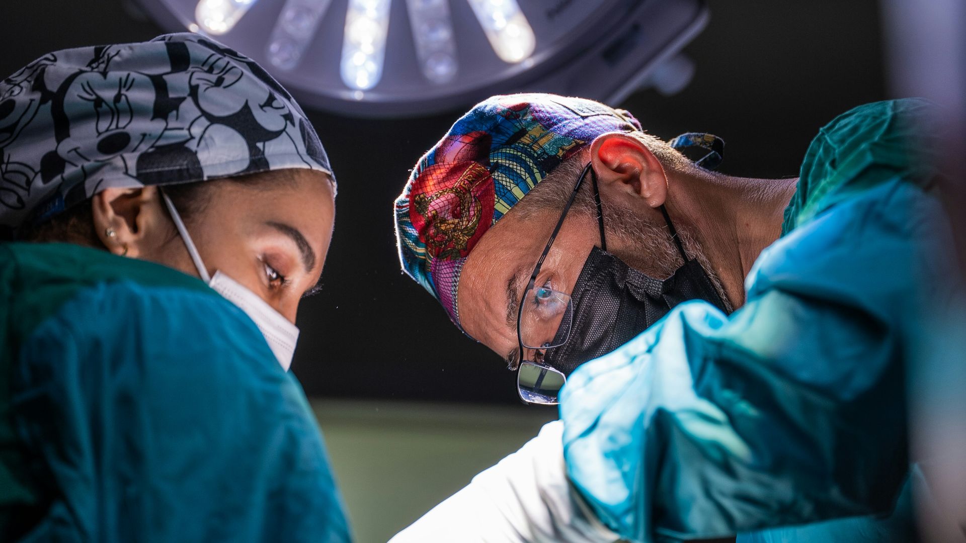two surgeons performing surgery on a patient in a hospital