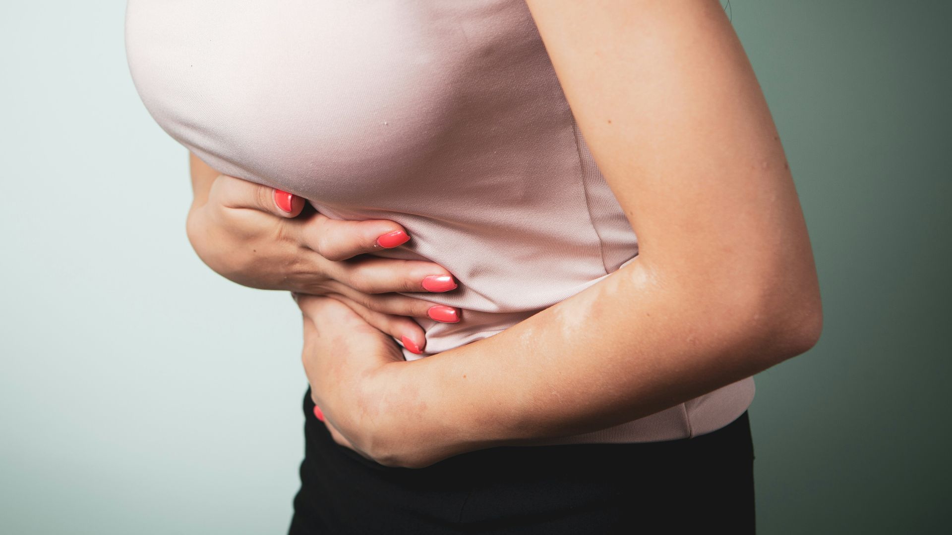 A person holding their stomach in pain.