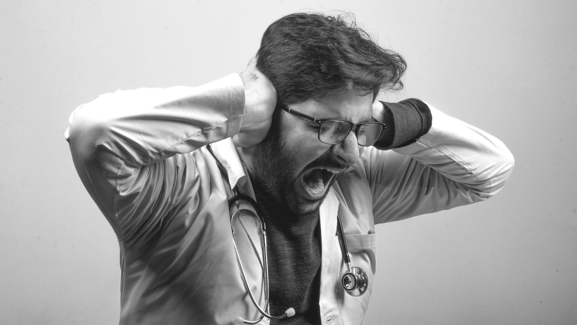 man in gray dress shirt wearing black framed eyeglasses