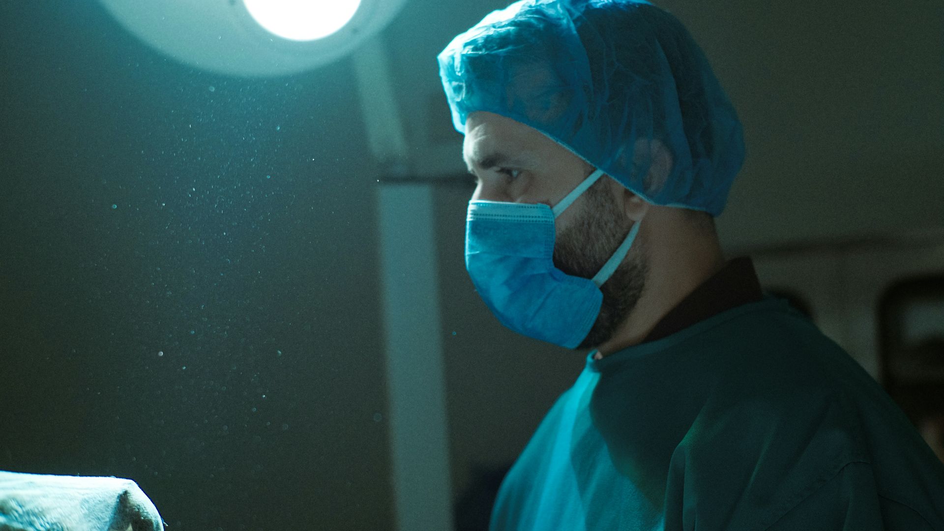 A man wearing a surgical mask in a room