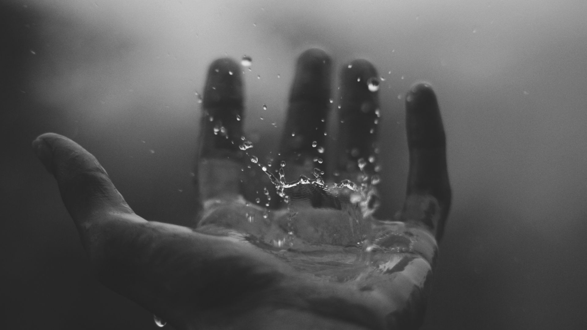time lapse photography of water hitting left palm