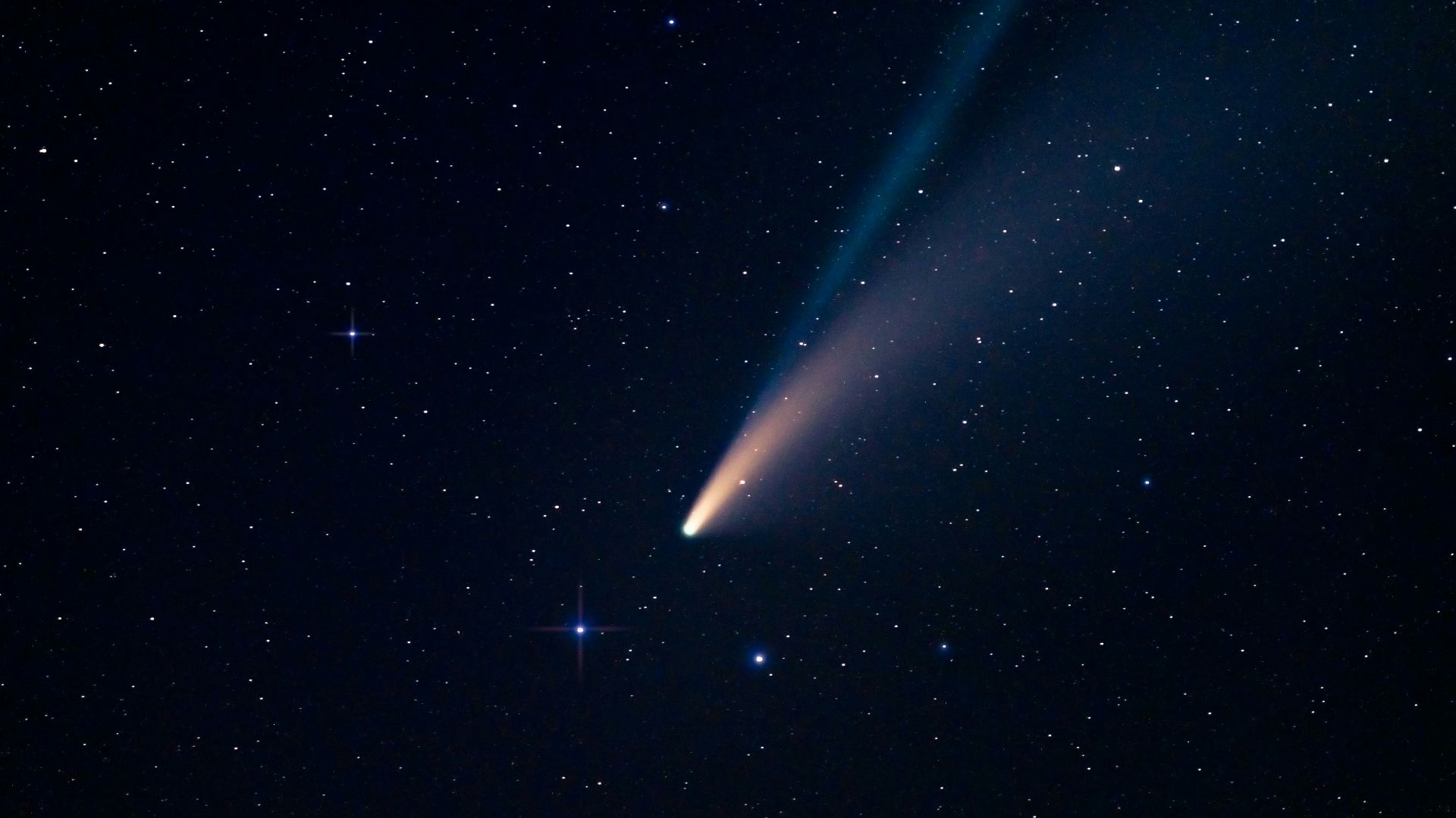 a comet is seen in the night sky