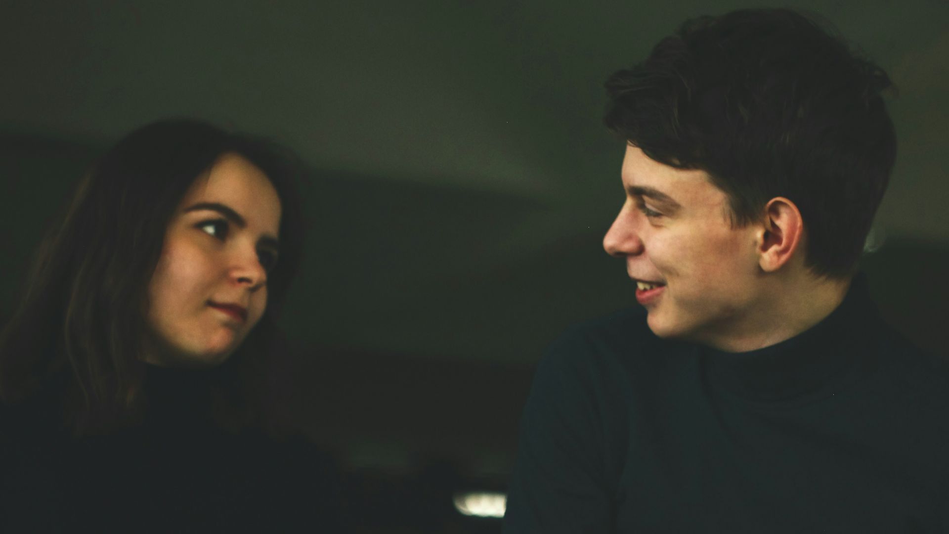 man wearing black shirt smiling at woman
