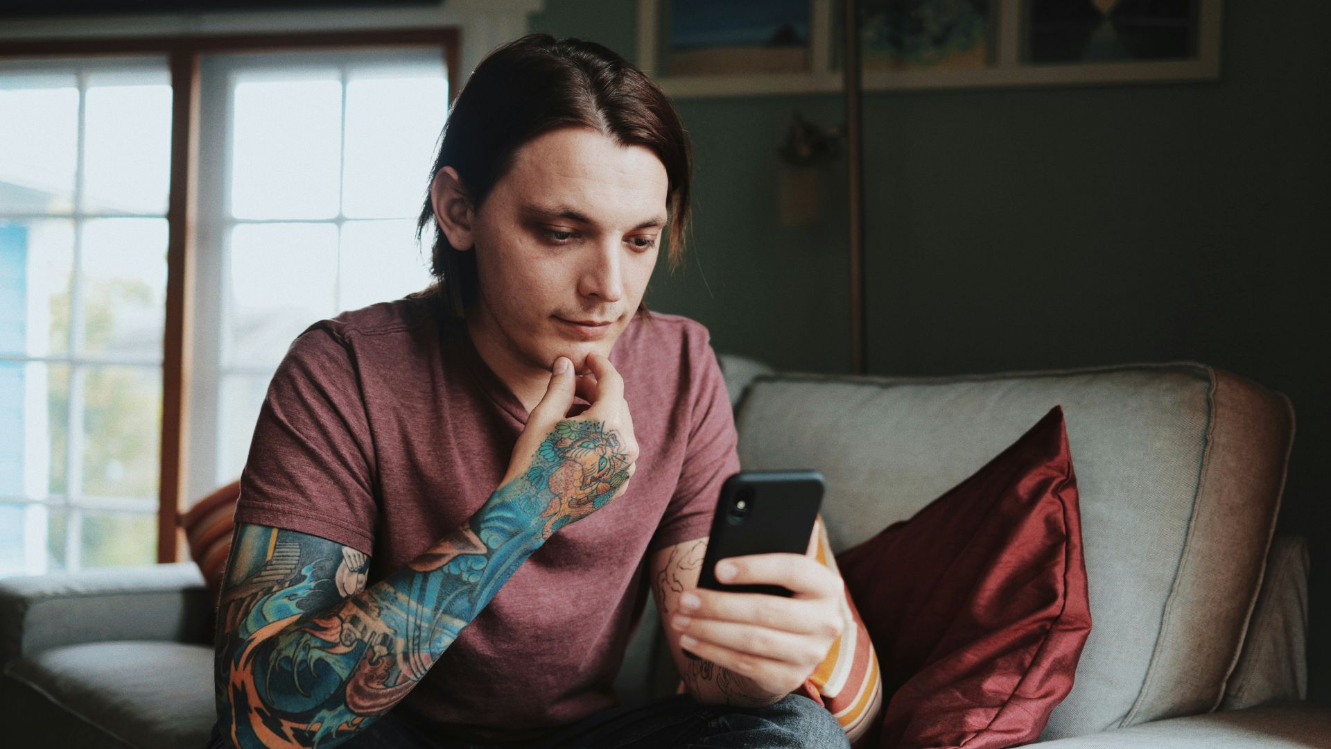 man using Android smartphone]