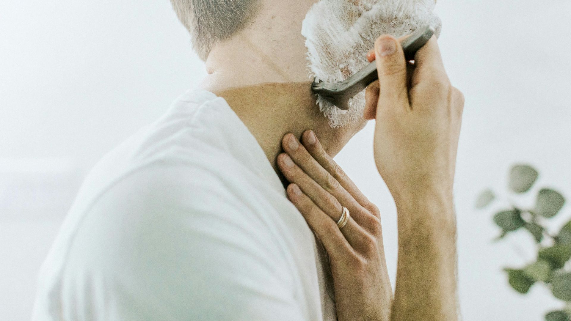 man shaving his beard