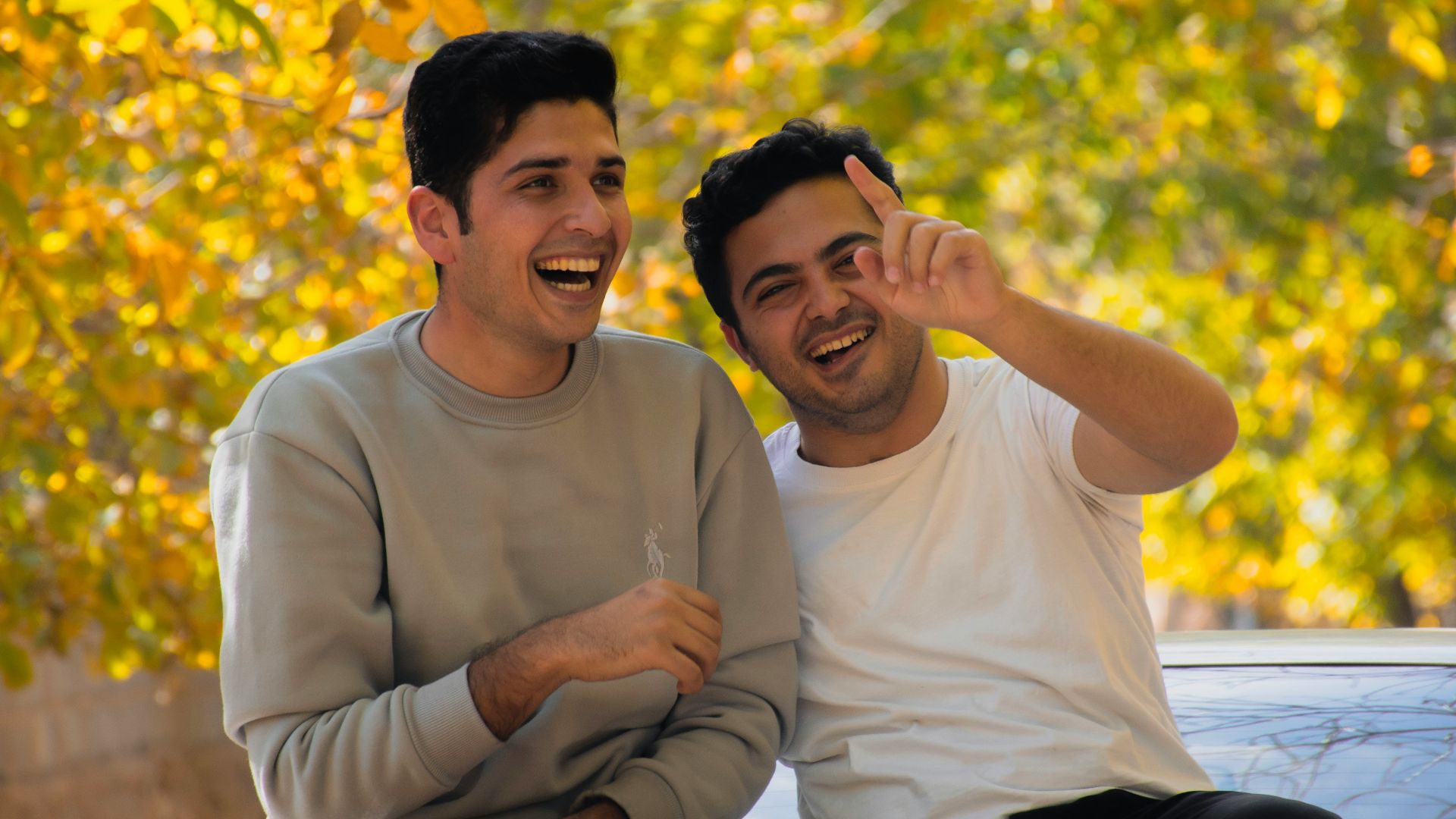 a couple of men sitting next to each other