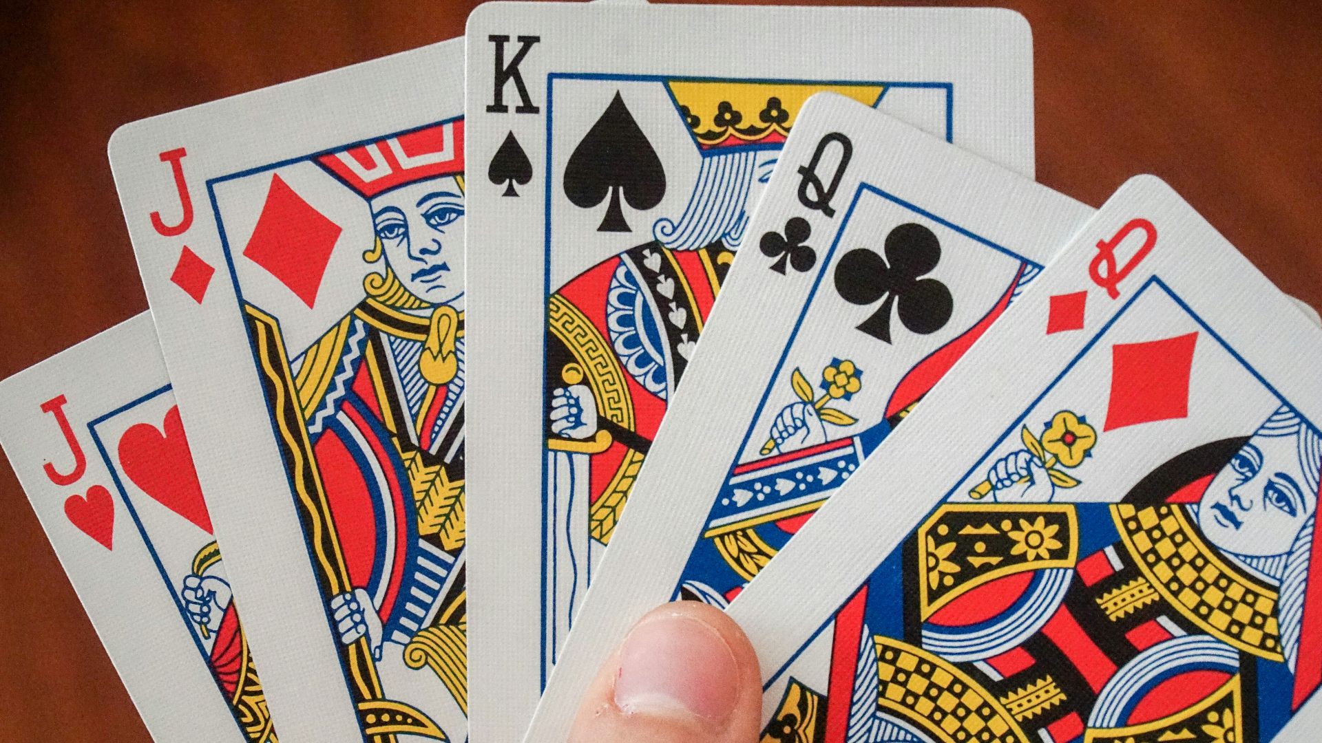 a hand holding a game card