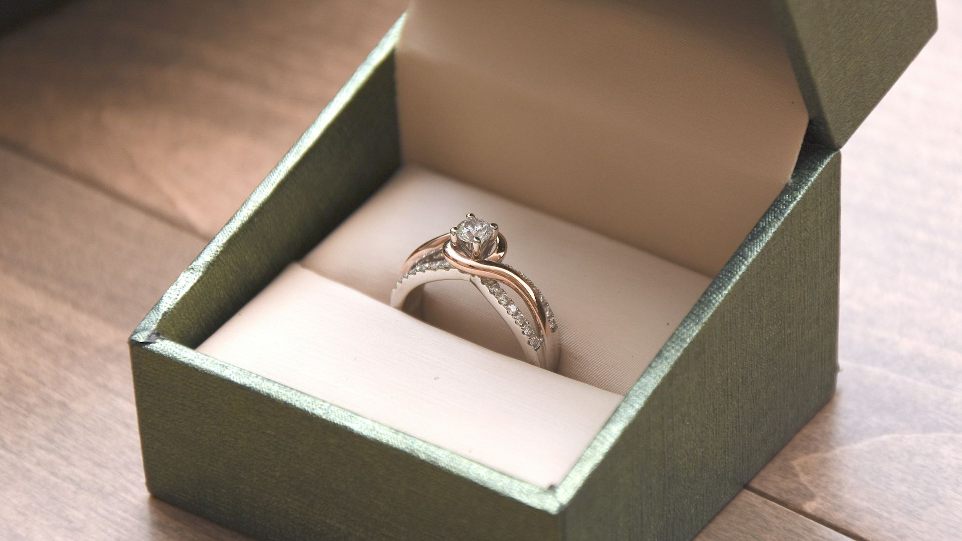 silver-colored ring with gemstone in a box