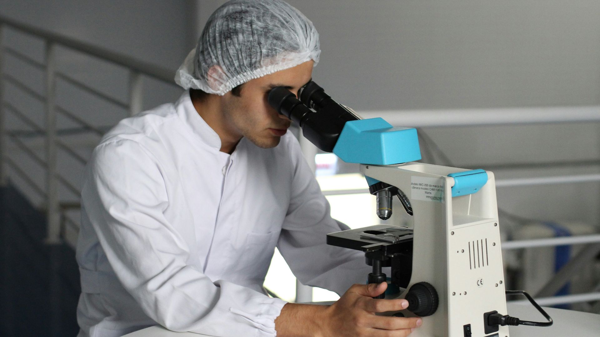 man sight on white microscope