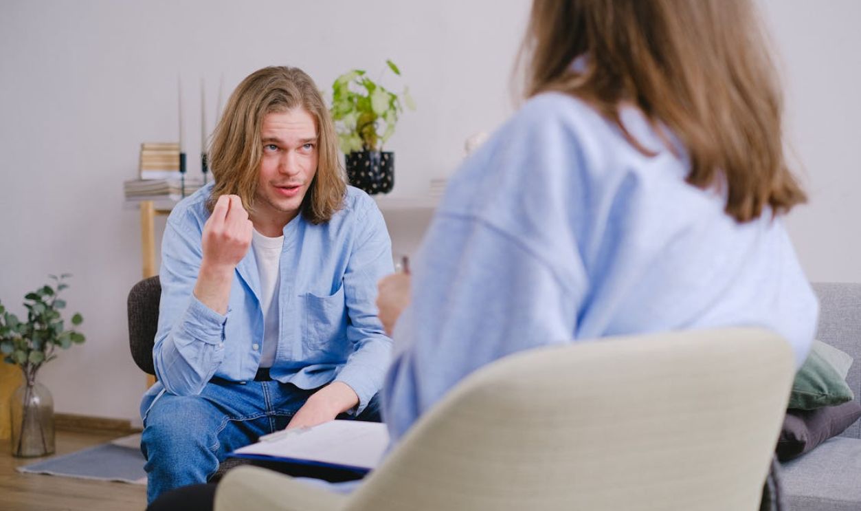 A Patient Gesturing and Talking to His Therapist