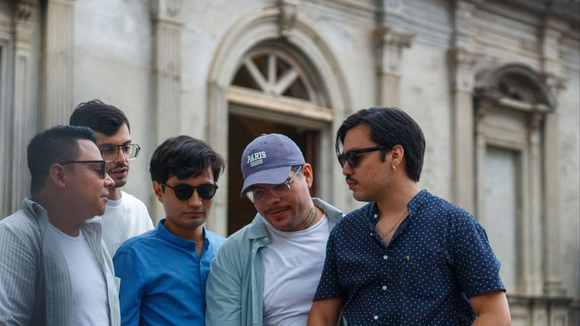 Group of men standing outside a building