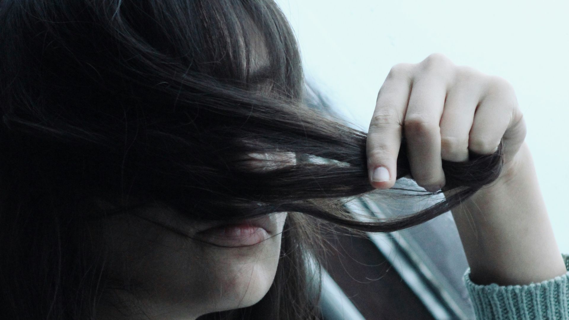 a woman with long hair sitting in a car