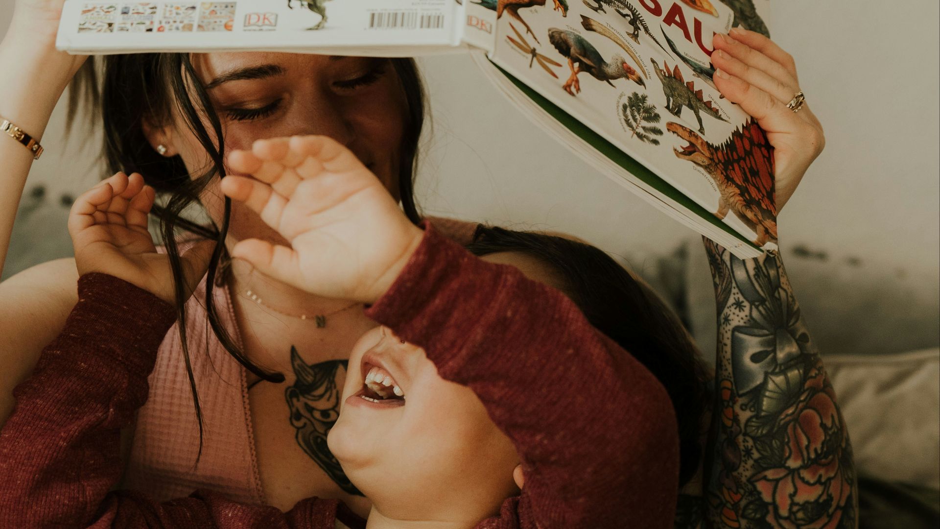 a woman is holding a book over her head