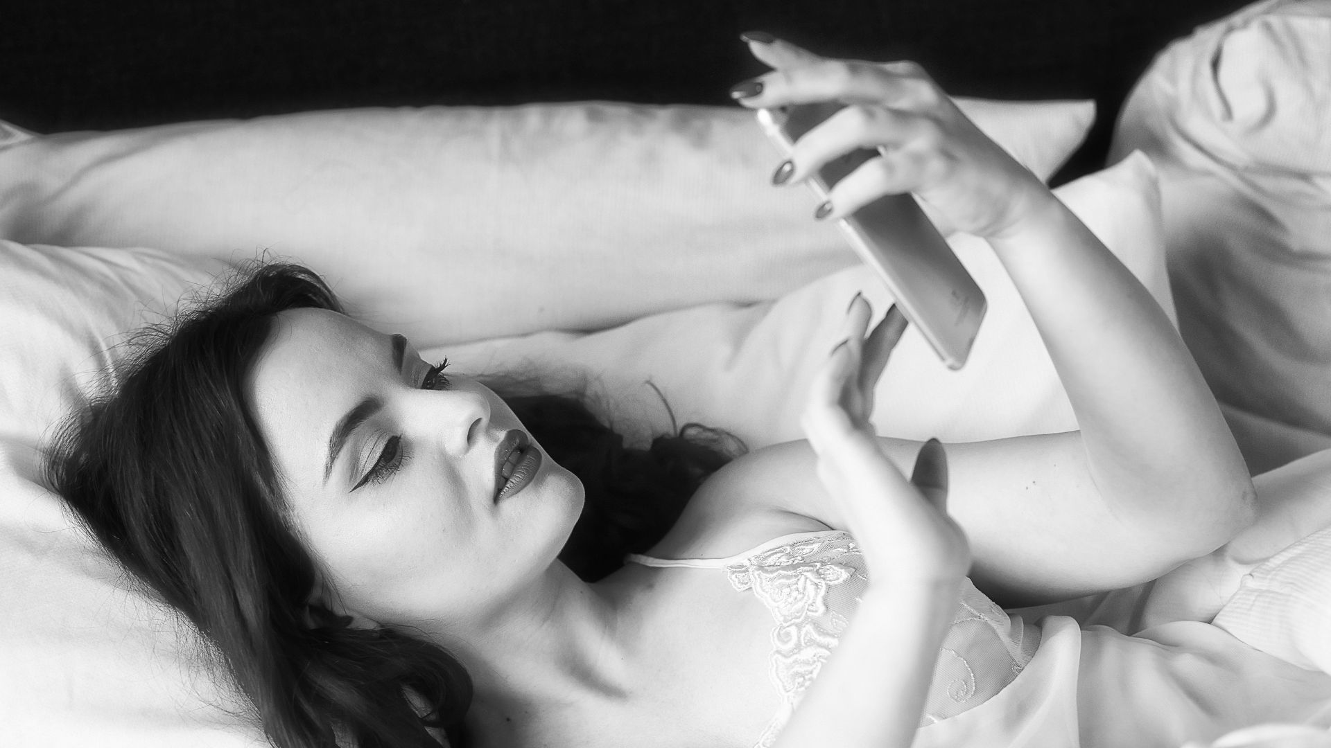 woman in white floral dress lying on bed