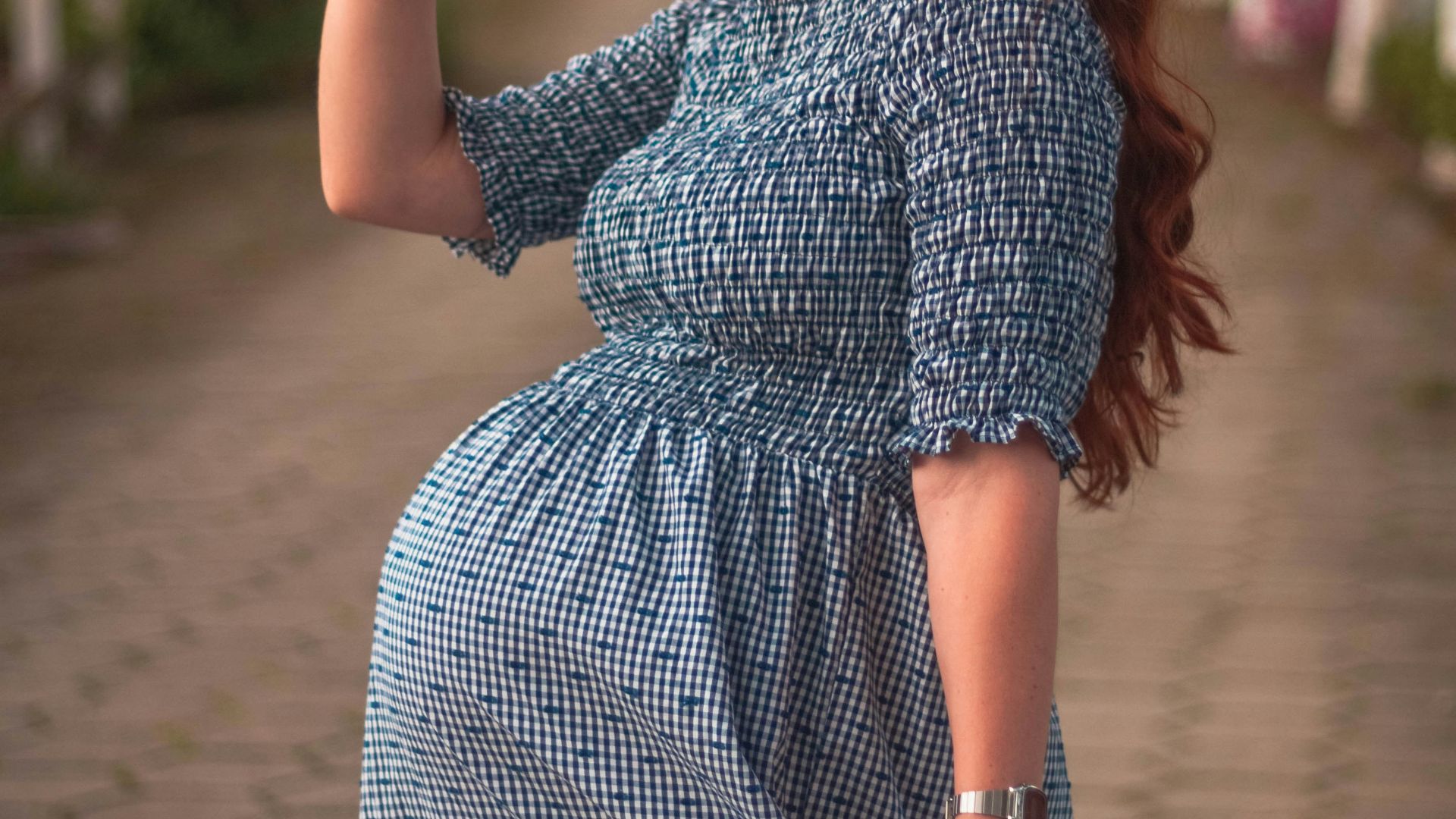 a woman in a blue dress and a straw hat