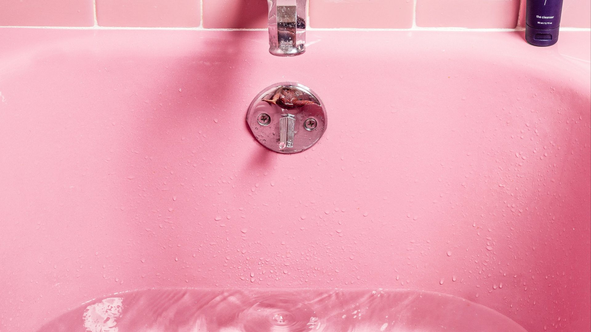 white bathtub filled with water