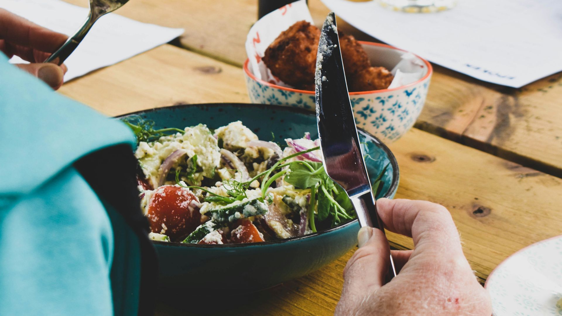 a person holding a knife and fork