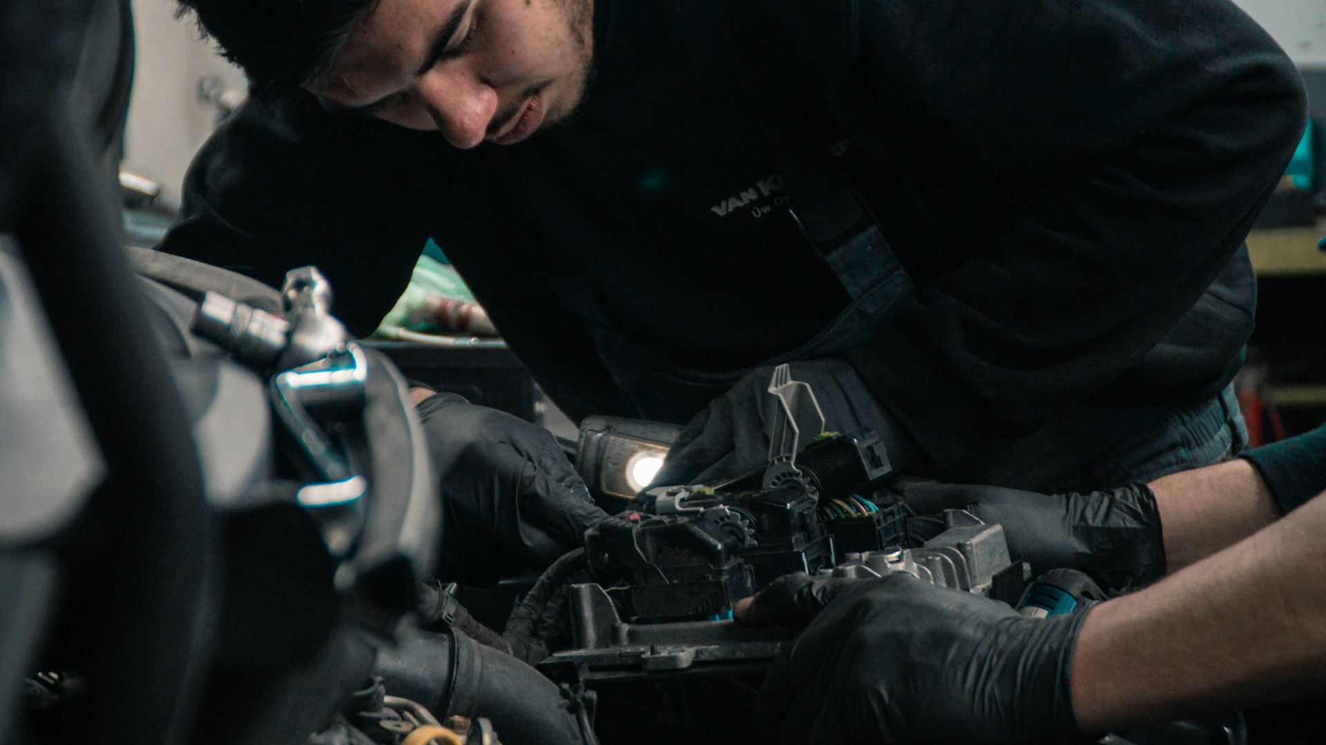 man in black jacket and blue denim jeans riding motorcycle