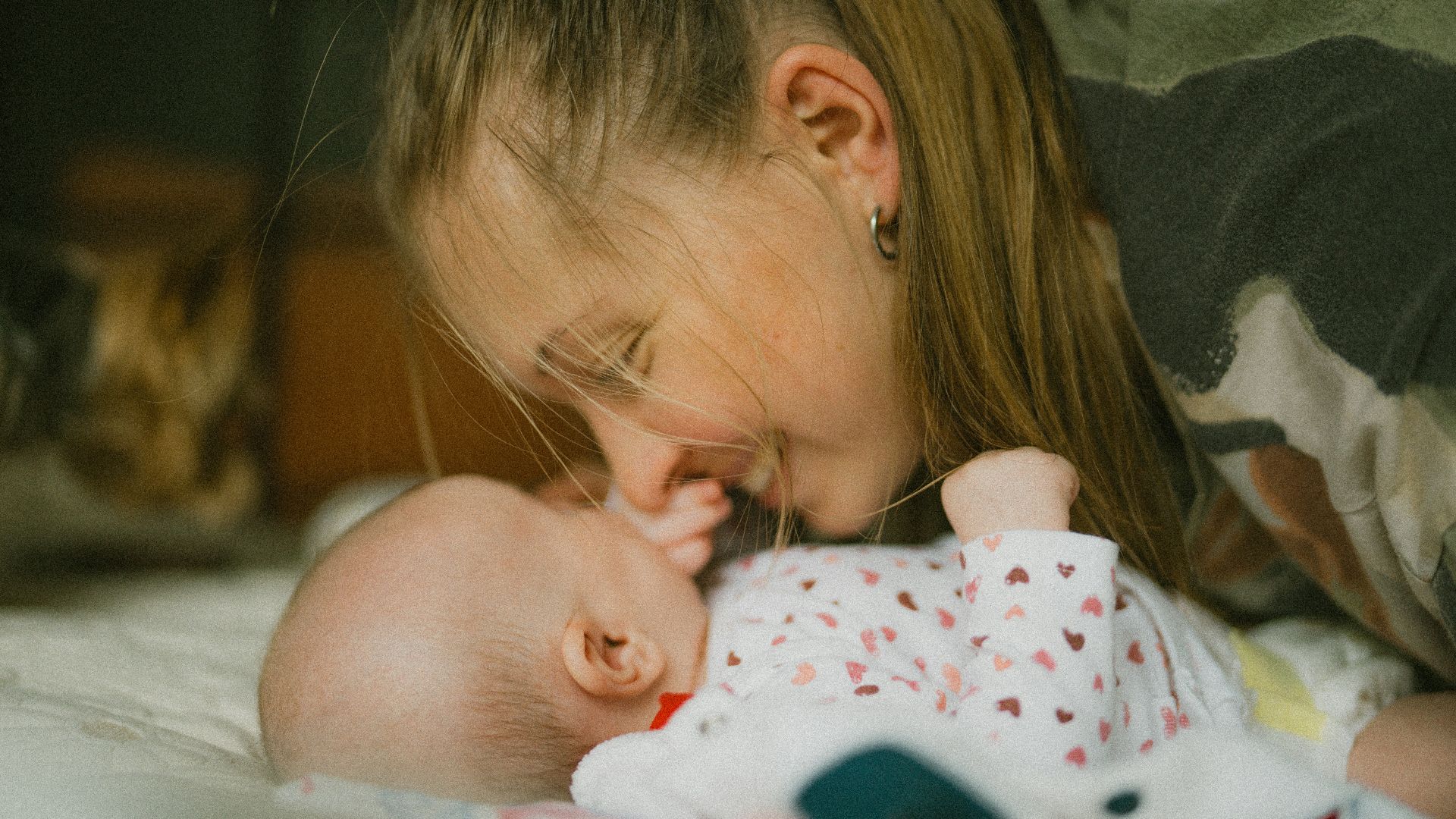 a woman holding a baby in her arms