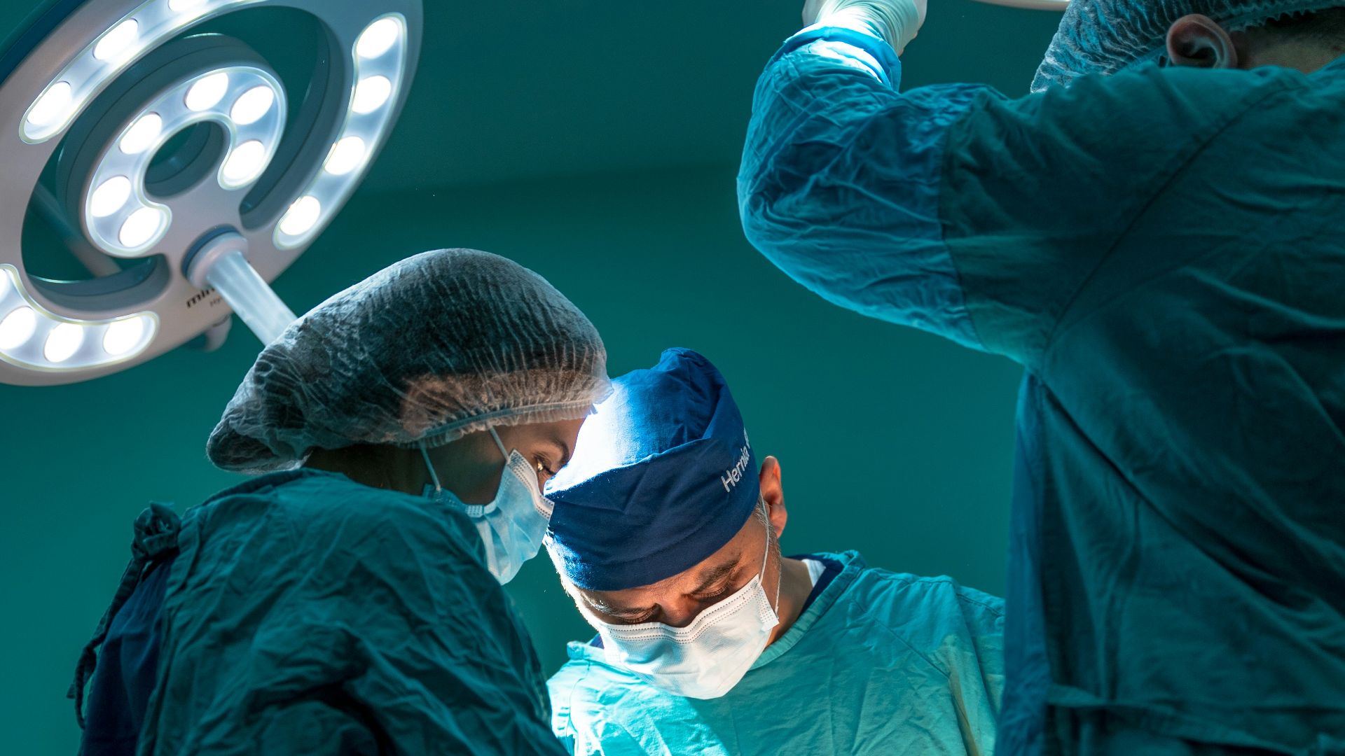 a group of doctors performing surgery on a patient
