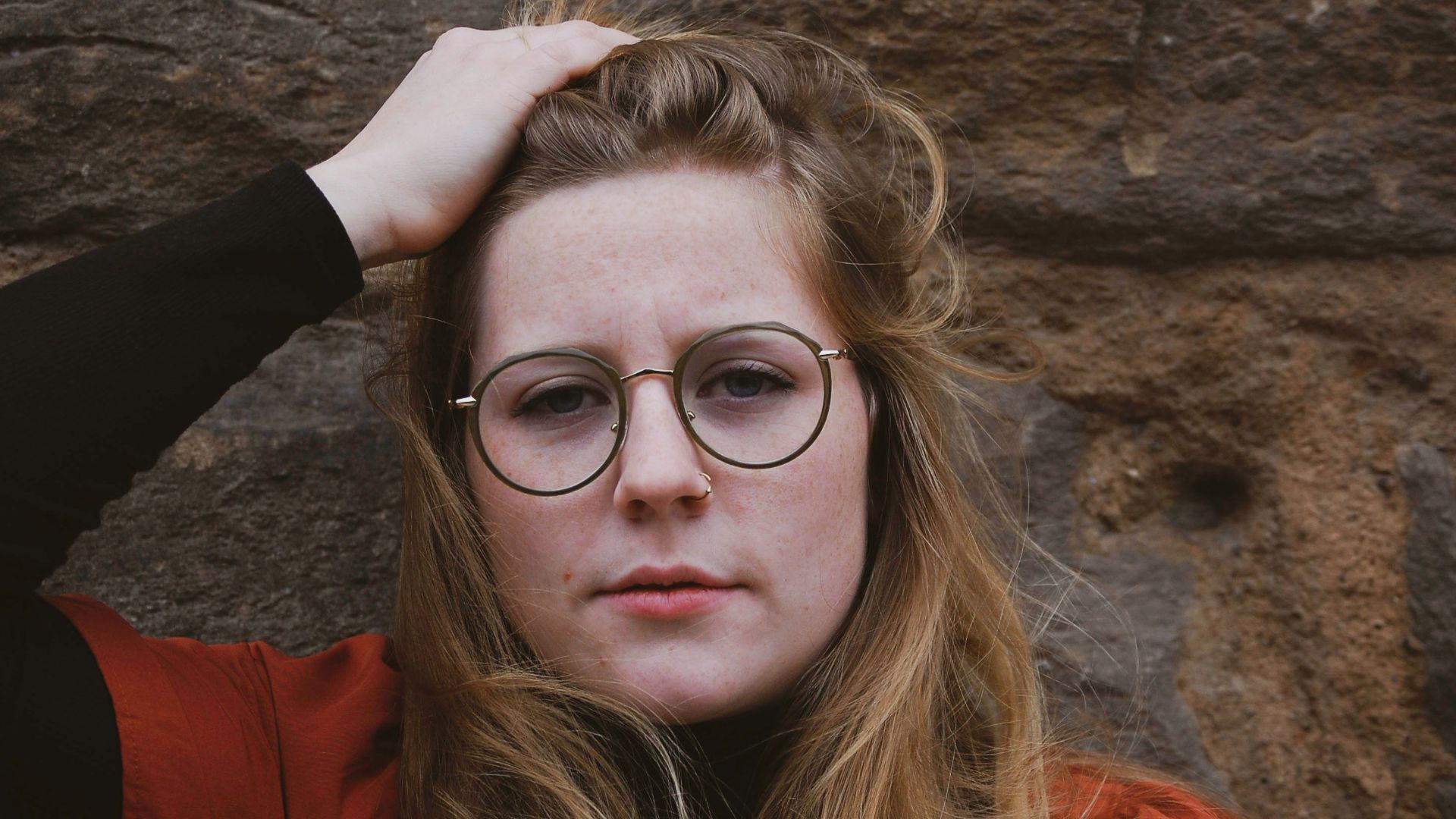 woman in red jacket wearing eyeglasses