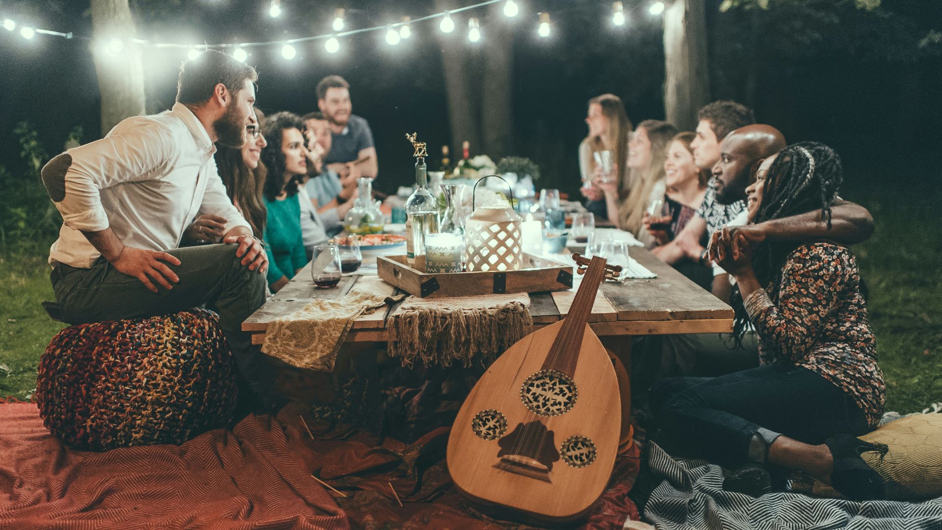 people sitting on chair in front of table with candles and candles
