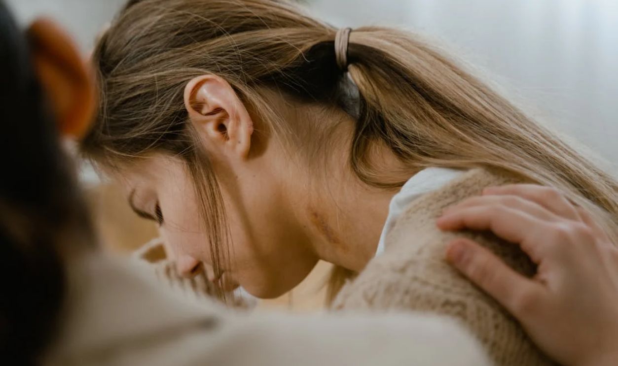 Woman Crying with a Hand on Her Shoulder