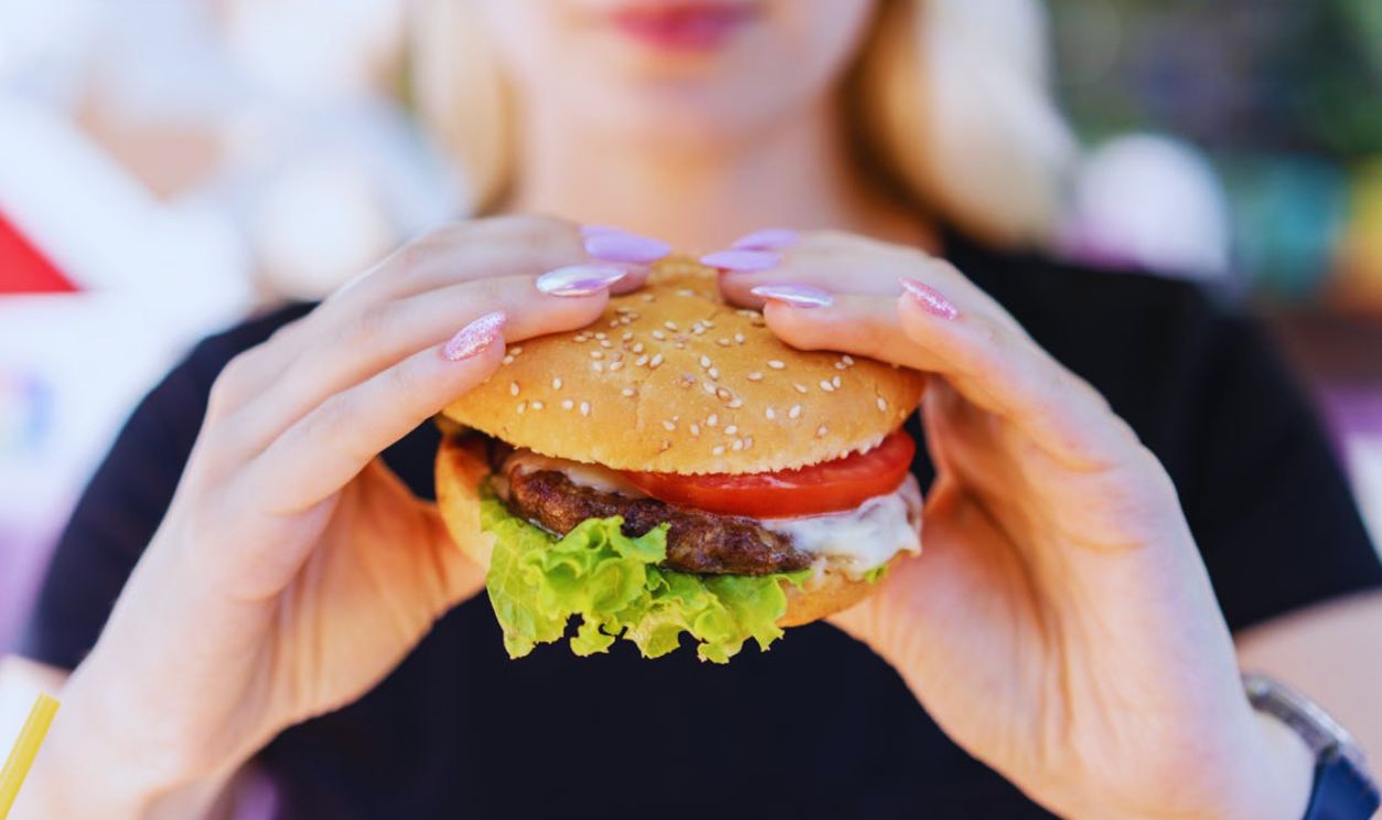 A Person Holding a Burger