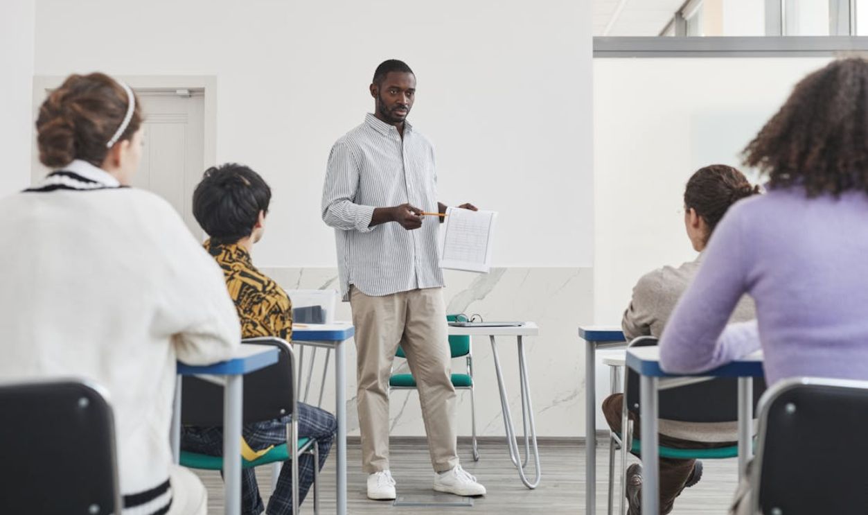 A Man Showing a Paper to His Students